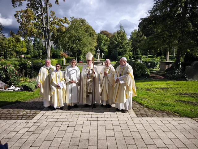 Archbishop Karl-Michael Soemer and clergy gathered outdoors following Colin’s ordination