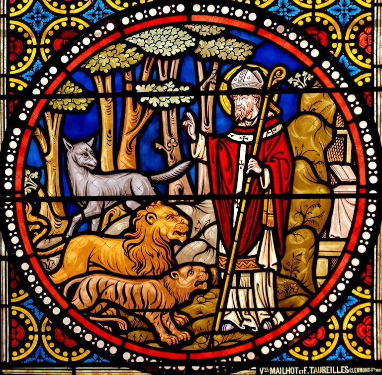 Stained glass window of a saint with animals in a church setting, used to symbolise episcopal consecration